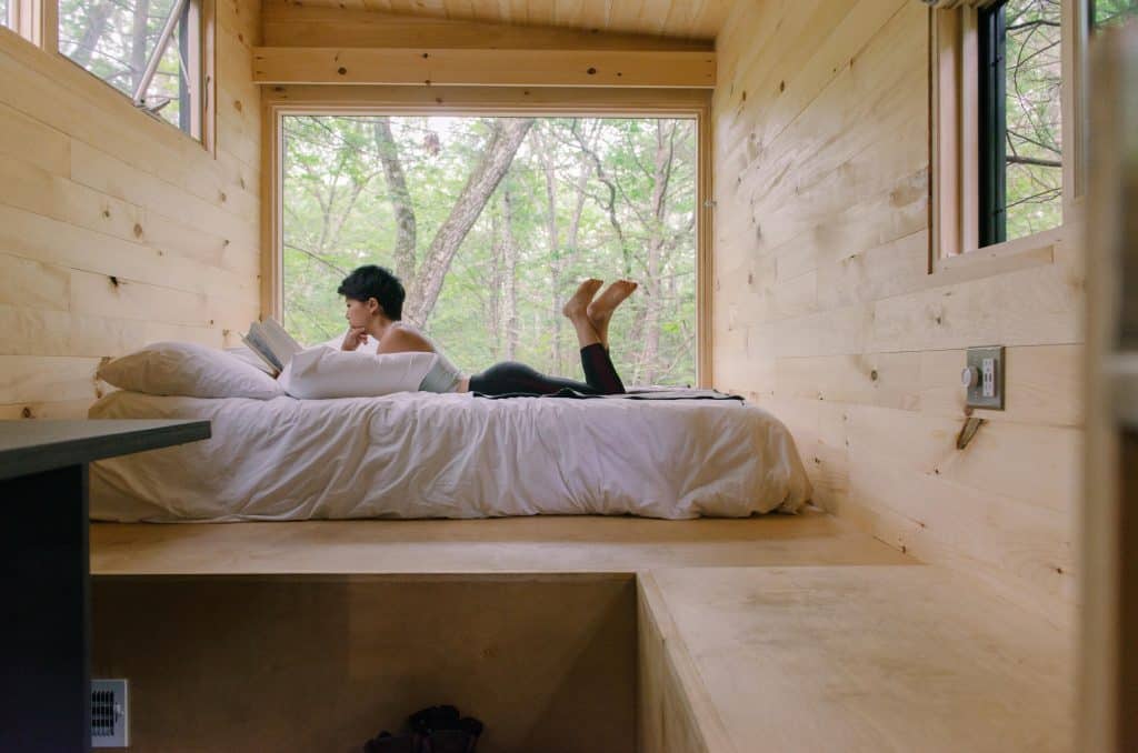 woman reading in bed in cabin