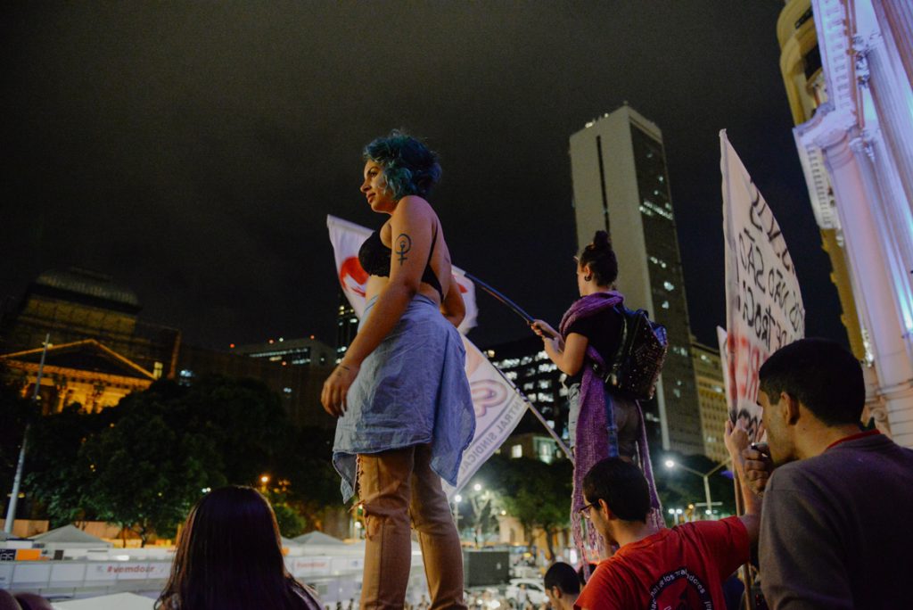 Protester stands above crowd