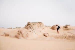 Man hikes through Cabo Polonio sand dune