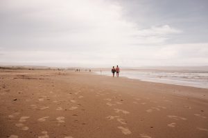 two men stroll on the beach in Uruguay