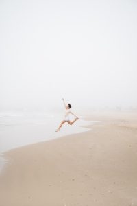Girl jumps into air on the cabo polonio beach