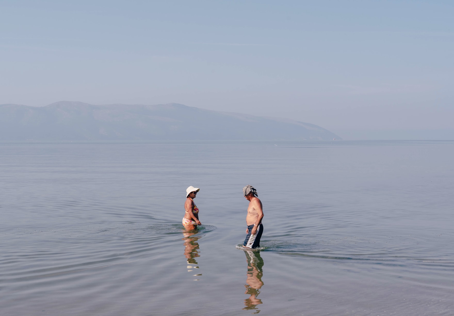 A man and a woman cross paths in the empty sea
