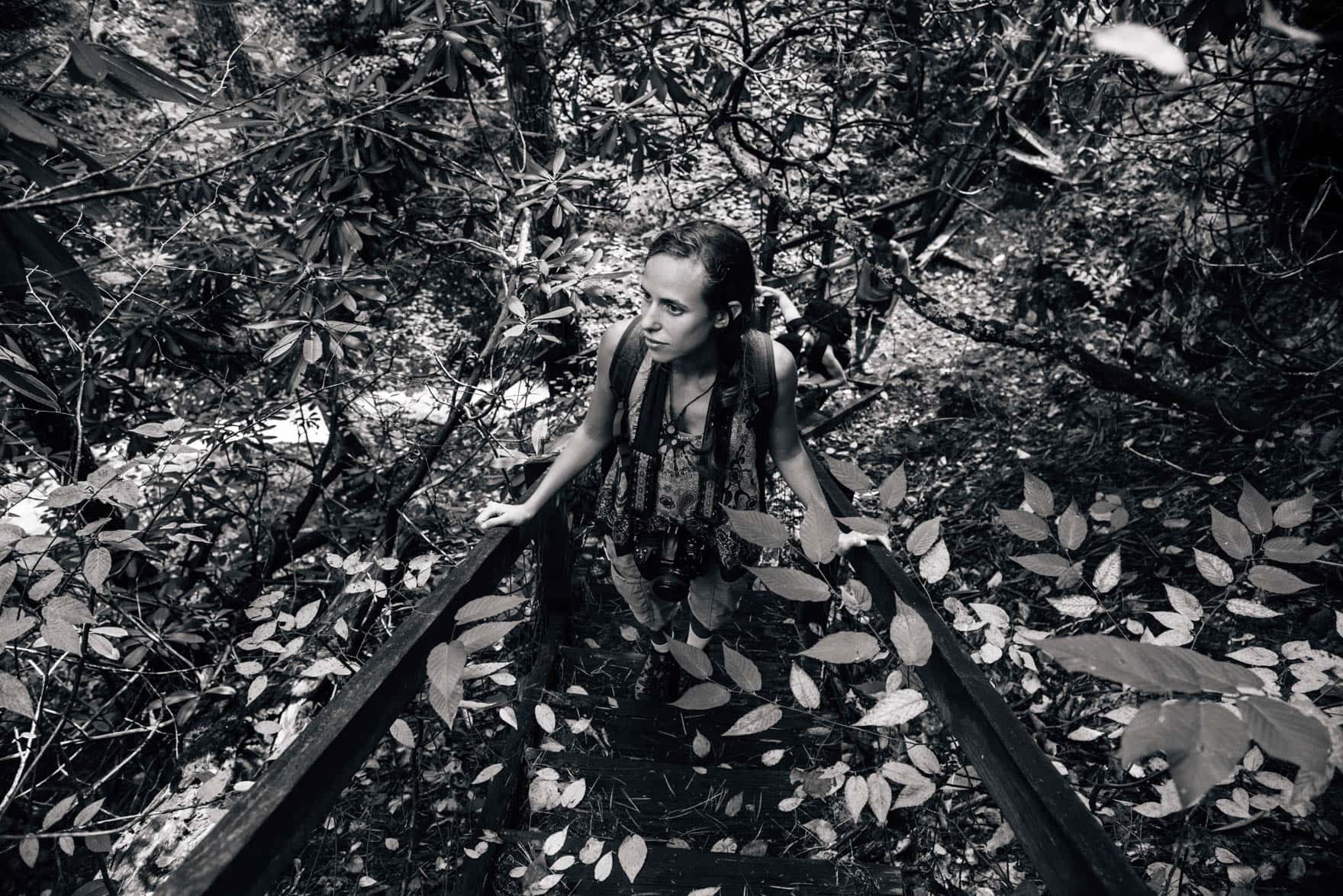 View of a woman standing on a trail with leafs encircling her